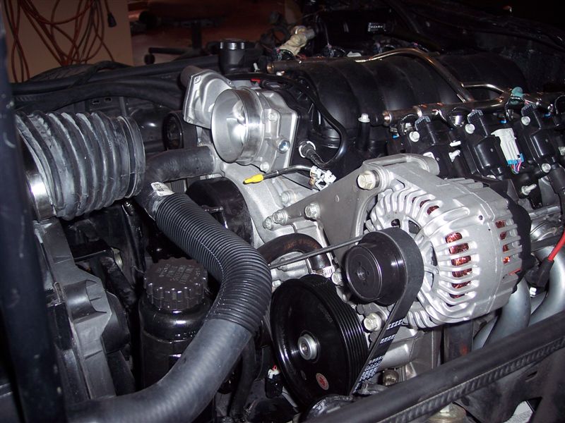 An LS2 Corvette alternator and power steering pump are connected to the '85 harness and steering rack.